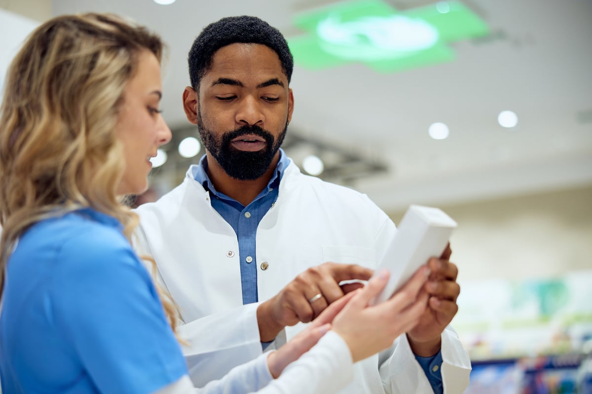 A pharmacist speaks to a patient. 